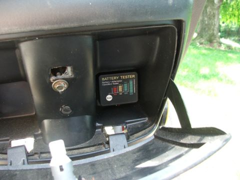 2008 Yamaha Zuma - A battery and alternator condition tester is visible inside a vehicle's compartment.
