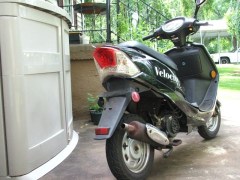 2008 Yamaha Zuma - Rear view of a black scooter with "Velocity" branding visible on its side panel.