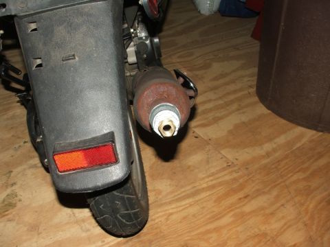 2008 Yamaha Zuma - Close-up view of a scooter's rear section, focusing on the exhaust pipe and fender.