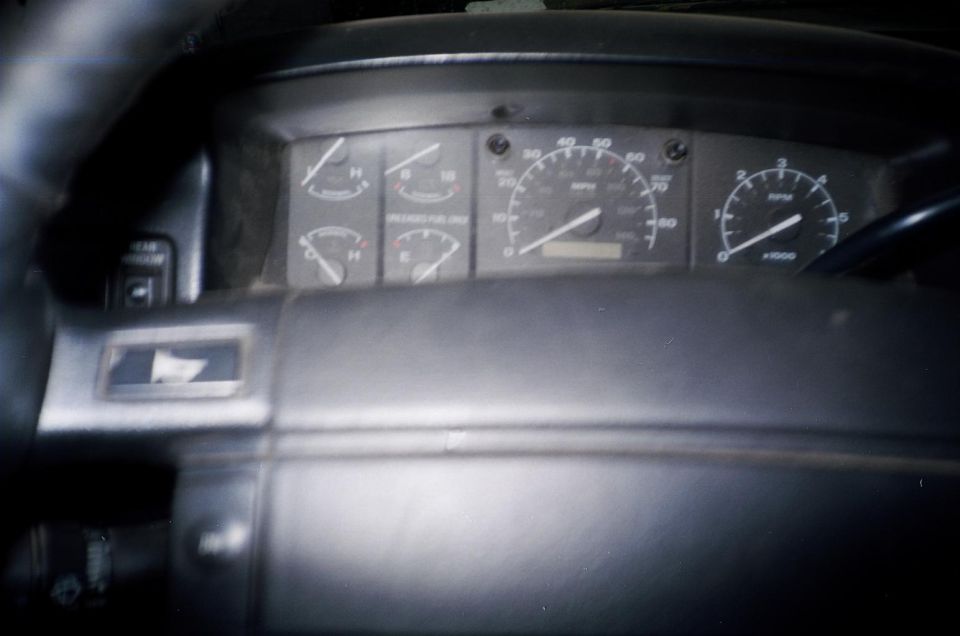 Gray 1990s Ford truck gauge cluster with 80 mph speedometer and tachometer