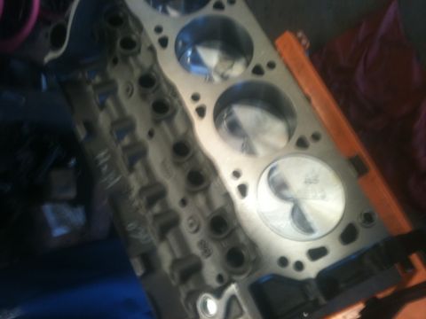 1993 Ford Bronco - This is a close-up view of an engine block, showing the pistons within the cylinders. Some text is visible on the block's surface.