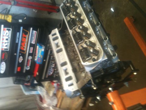 1993 Ford Bronco - Engine parts are laid out on a workbench next to a toolbox.