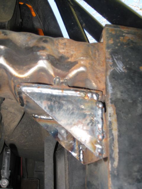1994 Ford Bronco - Close-up view of a heavily modified and welded metal frame, showing signs of rust and repair work.