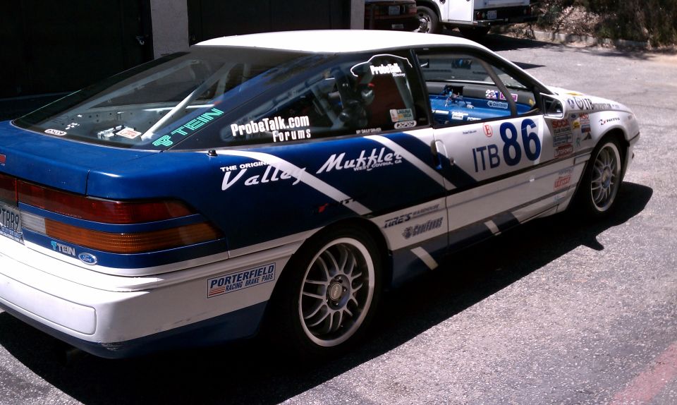 1990 Ford Probe race car with blue and white livery, number 86, and various sponsor decals