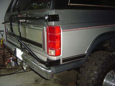 1986 Ford Bronco - Rear view of a 1986 Ford Bronco, showing the bumper, spare tire carrier, and taillight.