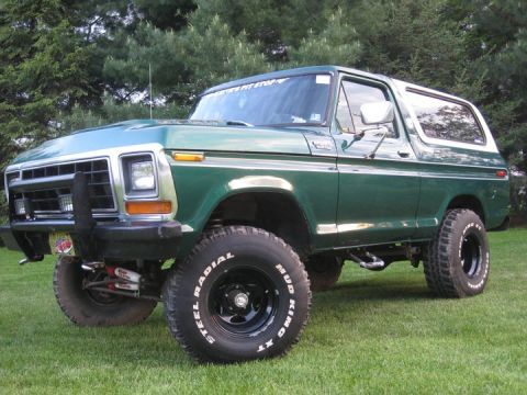 1979 Ford Bronco - This 1979 Ford Bronco features a green exterior with a white hardtop and aggressive off-road tires.