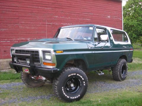 1979 Ford Bronco - This 1978 Ford Bronco features a prominent bull bar and off-road tires, parked outdoors.