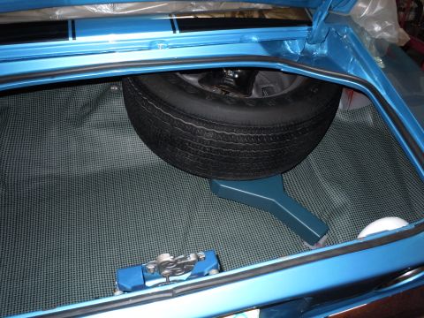 1972 Chevrolet Camaro - The trunk of a blue 1972 Chevrolet Camaro, a spare tire and a patterned liner.
