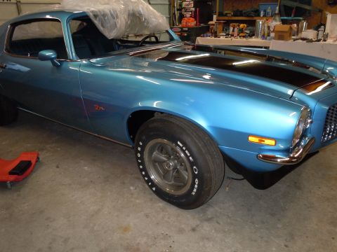 1972 Chevrolet Camaro - This blue muscle car features black racing stripes and a distinctive front fender and wheel design.