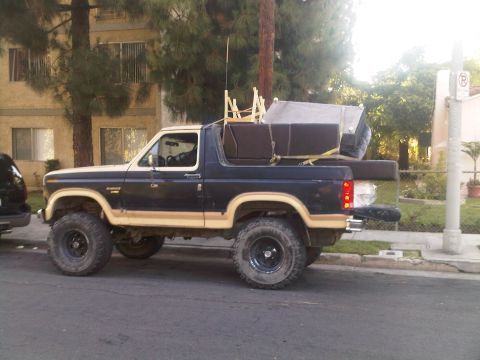 1986 Ford Bronco - This lifted Ford Bronco is loaded with furniture, ready for a move or a haul.