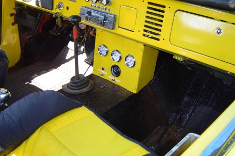 1974 Ford Bronco - Interior view of a 1974 Ford Bronco, a yellow dashboard and floor-mounted shifter.