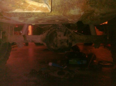 1995 Ford Bronco - The underside of a vehicle is shown, focusing on the rear axle and suspension. The year is not discernible from this view.