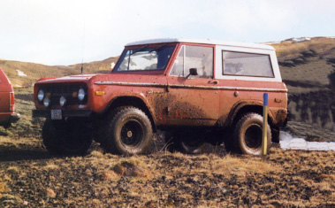 1974 Ford Bronco - This 1974 Ford Bronco is shown off-road, covered in mud.