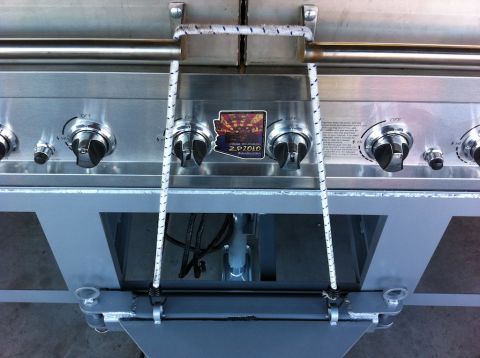 1987 Suzuki Samurai - A close-up view of a gas grill, showing its control panel and burners.
