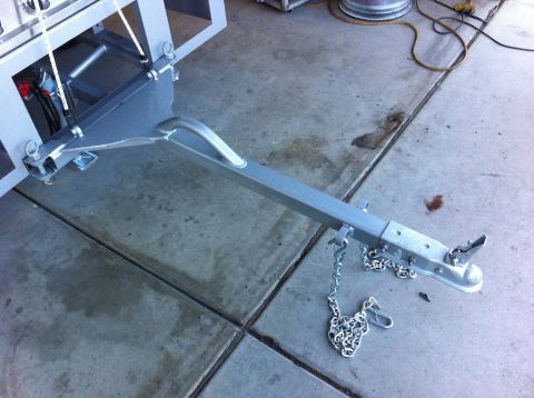 1987 Suzuki Samurai - Close-up view of a trailer hitch assembly, including the coupler and safety chains.