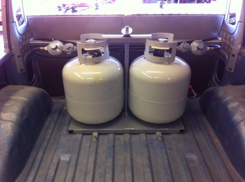 1987 Suzuki Samurai - Propane tanks installed in the bed of a pickup truck, with regulators attached.