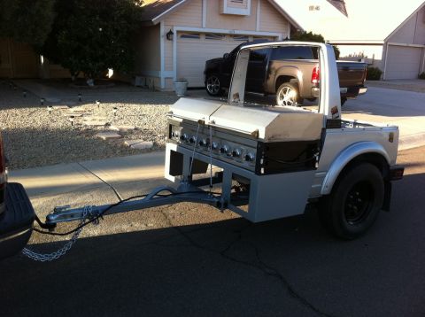 1987 Suzuki Samurai - A Suzuki Samurai has been modified to carry a large barbecue grill and is being towed by another vehicle.