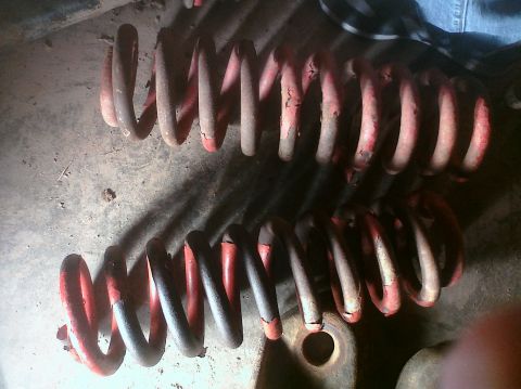 1995 Ford Bronco - Two red and black coil springs are shown, possibly for a lifted truck or SUV.