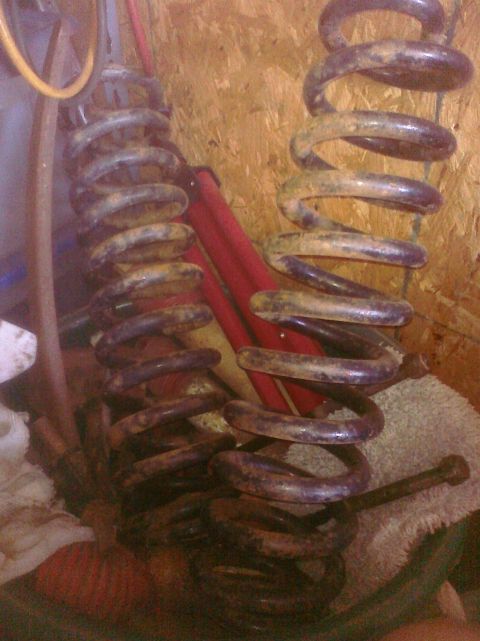 1995 Ford Bronco - Two used coil springs are shown, likely for a vehicle's suspension system.