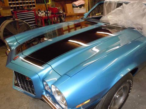 1972 Chevrolet Camaro - A blue 1972 Chevrolet Camaro with black racing stripes is parked in a garage.