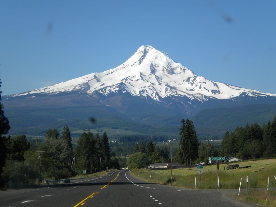 Road leading towards Mount Hood under a clear blue sky