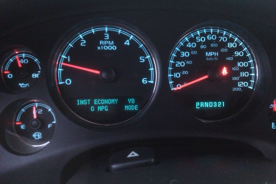 Dashboard gauges showing RPM, MPH, fuel level, and instant economy. PRND321 is displayed