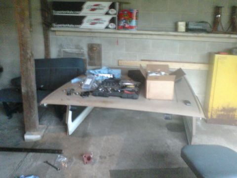 1988 Ford Bronco - Workbench setup with various automotive parts and tools laid out for a project.