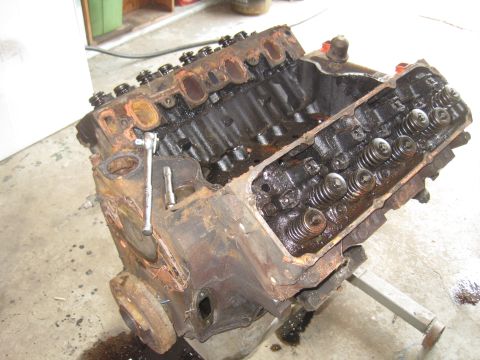 1979 Ford Bronco - This is a V8 engine block, likely undergoing repair or rebuild. It is heavily rusted and shows internal components.