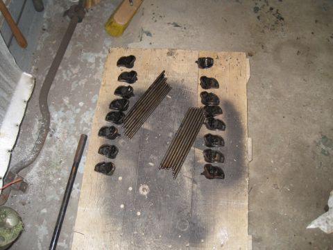1979 Ford Bronco - Engine components, including rocker arms and pushrods, are organized on a wooden surface.