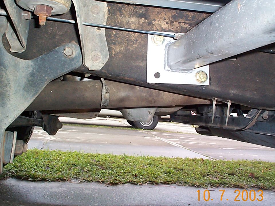 driver's side front pad mount. There is a fuel line bracket that runs behind this mount, bolts to the brack must be removed and the bracket pushed out of the way.