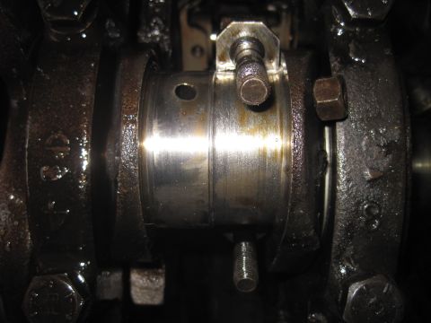 1979 Ford Bronco - Close-up view of an engine's crankshaft bearing, showing wear and oil residue.
