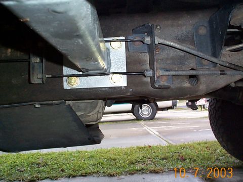 1992 Ford Bronco - Rear driver's side pad mounting, there is about a 1/4 inch clearance between the ebrake cable and the are. The holes drilled here, must be…