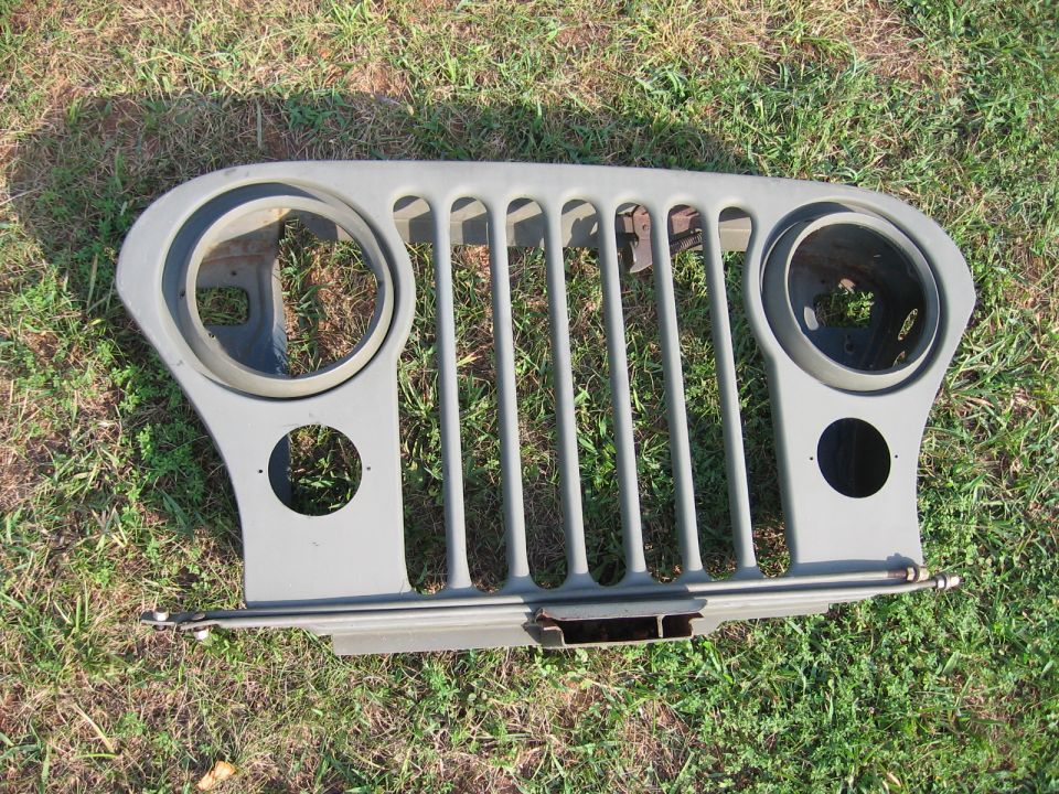 Gray Jeep CJ grille with vertical bars and round headlight openings