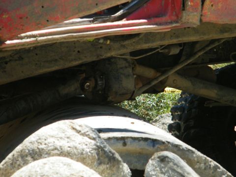 1982 Ford Bronco - Close-up of a vehicle's undercarriage, focusing on the drivetrain components and suspension.