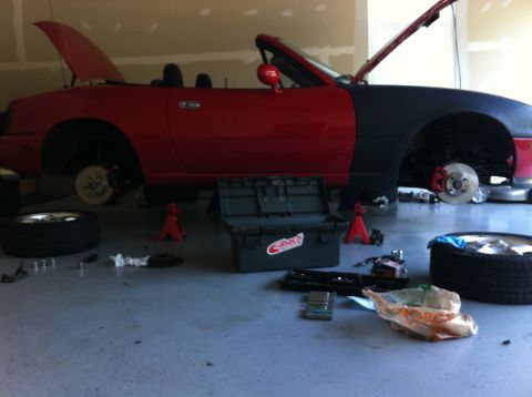 1990 Mazda Miata - Miata in garage with wheels off for brake service.