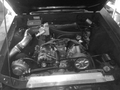 1995 Ford Probe - The engine bay features a turbocharger and a Trick Flow intake manifold, suggesting performance modifications.