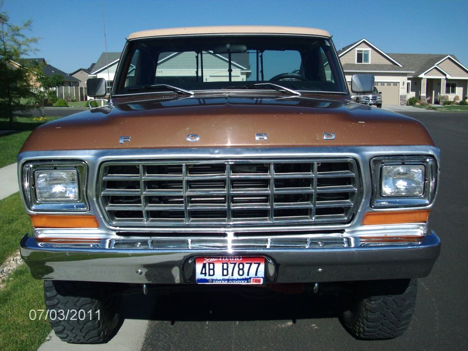 Front view of a 1979 Ford F-150 pickup truck with a chrome grille and a tan roof
