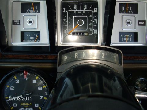 1979 Ford F-150 - Dashboard gauges and gear selector from an older vehicle interior.