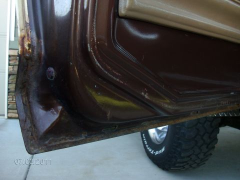 1979 Ford F-150 - The photo shows the lower door jamb and a tire of a truck, with visible rust and a date stamp.
