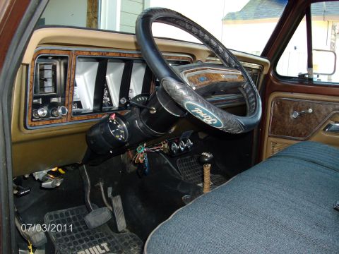 1979 Ford F-150 - The interior of a 1979 Ford F-150 shows its dashboard, steering wheel, and seating.
