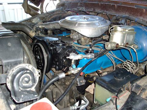 1979 Ford F-150 - Engine bay of a 1979 Ford F-150, the AC compressor and brake master cylinder.