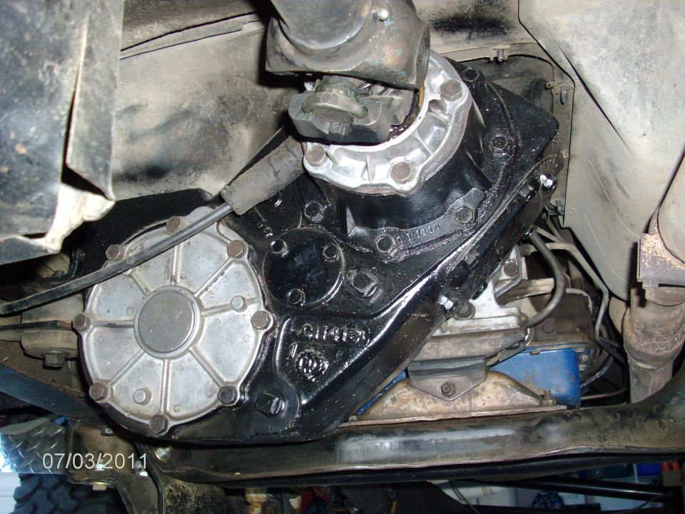 Transfer case with silver cover and black housing