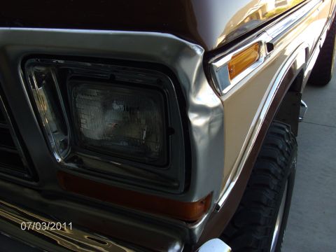 1979 Ford F-150 - Close-up of the front passenger side of a 1979 Ford F-150, showing the headlight and fender.