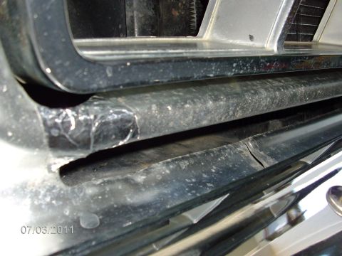 1979 Ford F-150 - A close-up view of the front grille and bumper area of a vehicle, showing some wear and tear.