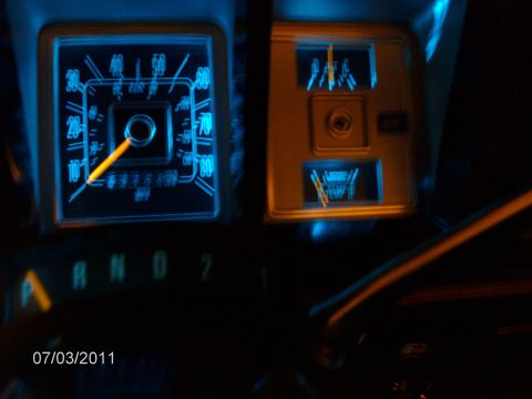 1979 Ford F-150 - Interior view of a 1979 Ford F-150 dashboard, highlighting the blue illuminated speedometer and fuel gauges.