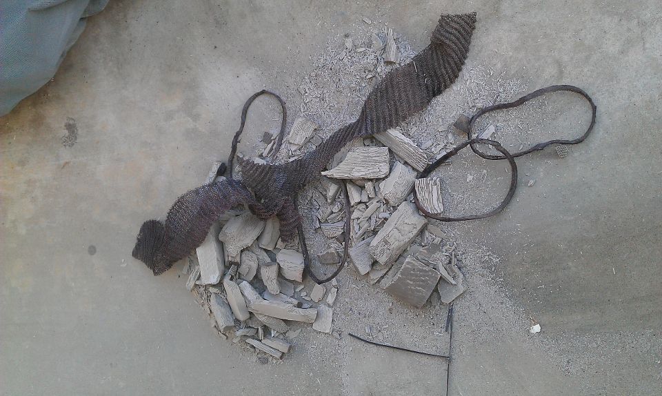 Pile of debris and twisted metal on concrete