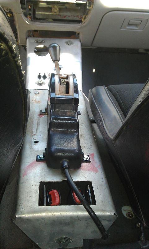 1992 Ford Ranger - The interior of a vehicle displays a shifter mechanism and seating, with exposed metalwork on the console.
