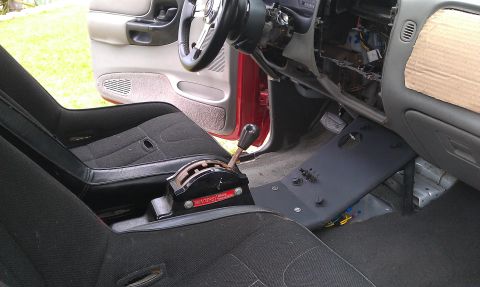 1992 Ford Ranger - The interior of a red truck shows racing seats and a Winters shifter, with the dashboard partially disassembled.