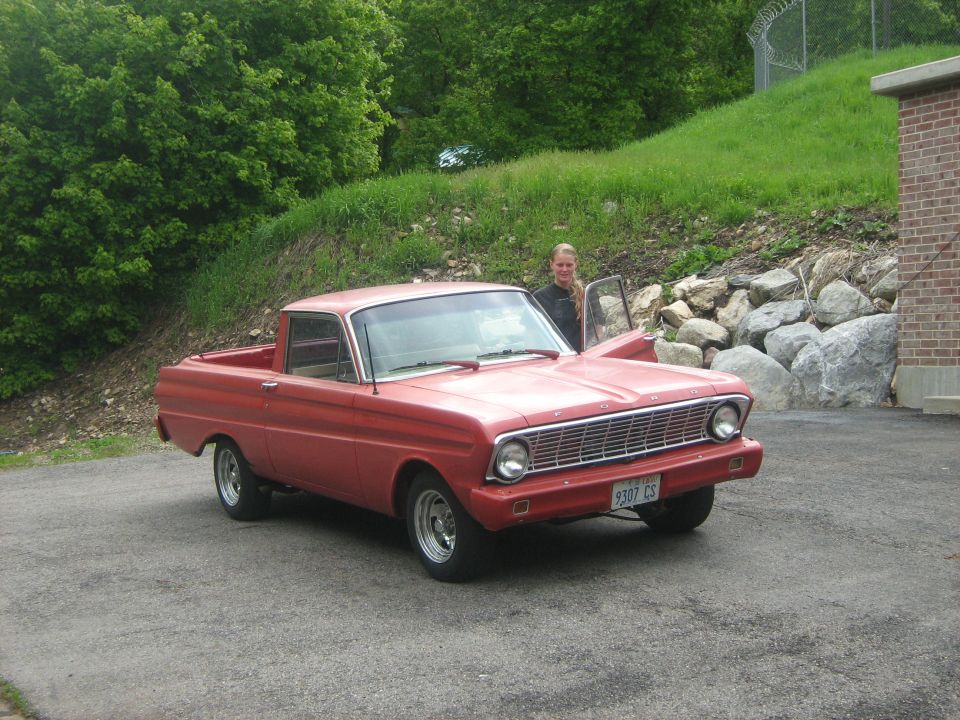 Red 1964 Ford Ranchero with woman in door