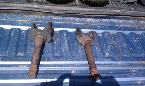 1979 Ford Bronco - Two driveshaft yokes are shown on a blue truck bed.